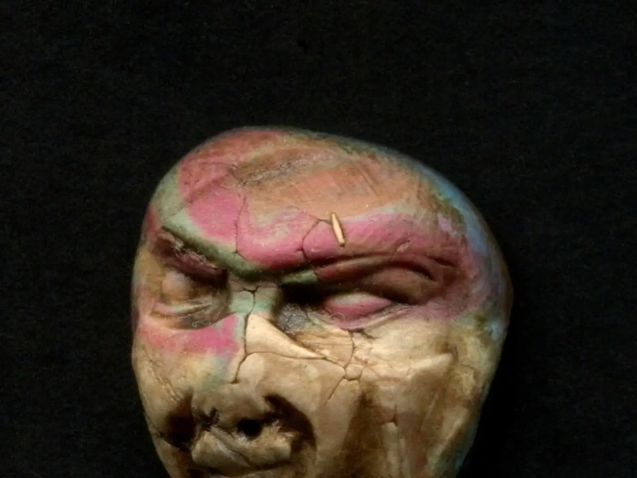 This picture contains artifact or a skull and in the background, it is dark.