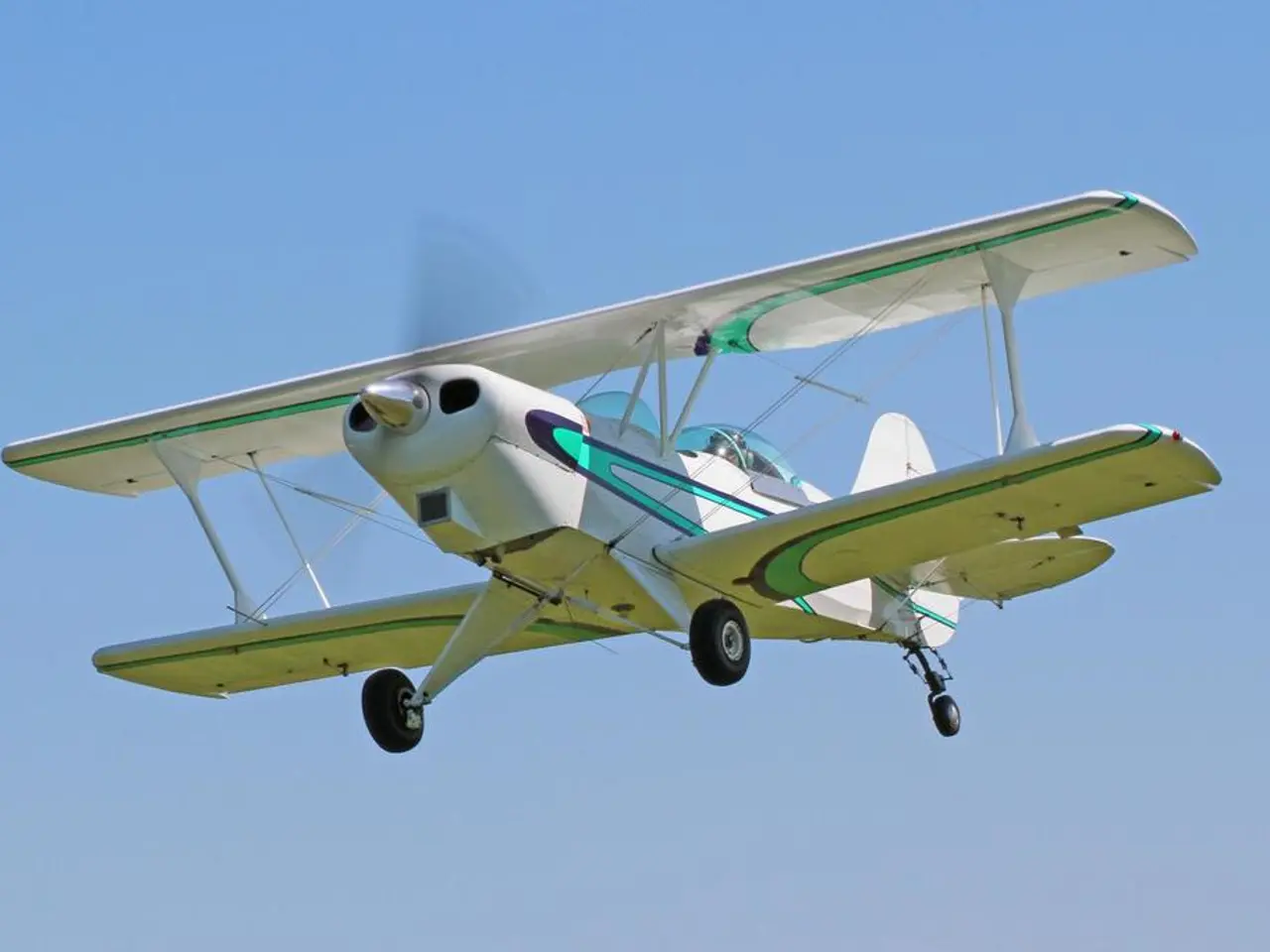 In this image I can see an aircraft in the air and in the background I can see the sky.