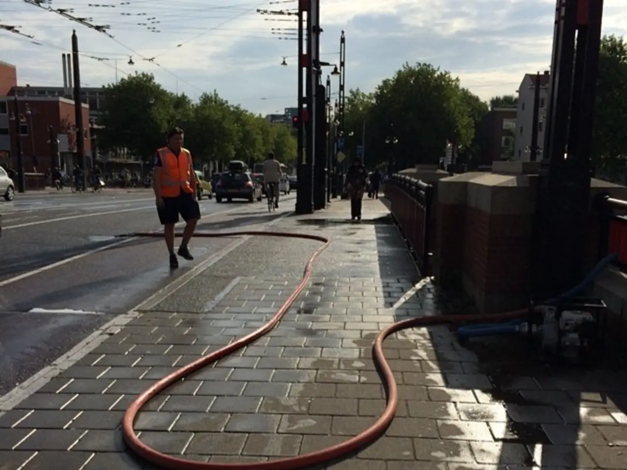 This image is clicked on the road. To the left there is a road. There are vehicles moving on the...