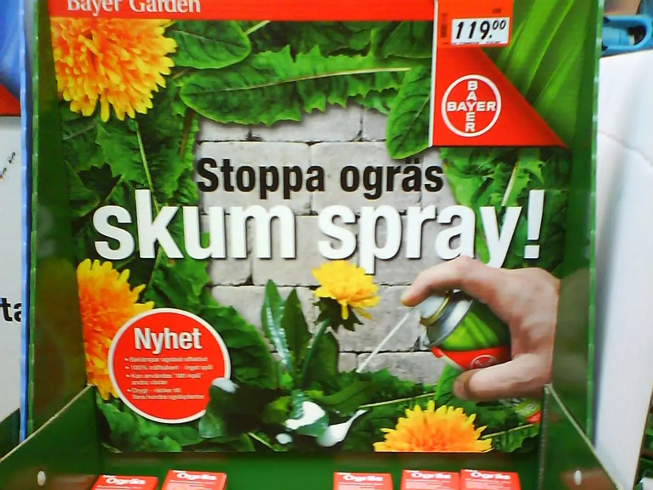 In this image in front there are spray boxes. Behind them there is a banner.