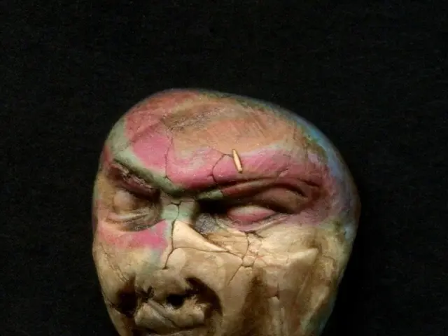 This picture contains artifact or a skull and in the background, it is dark.