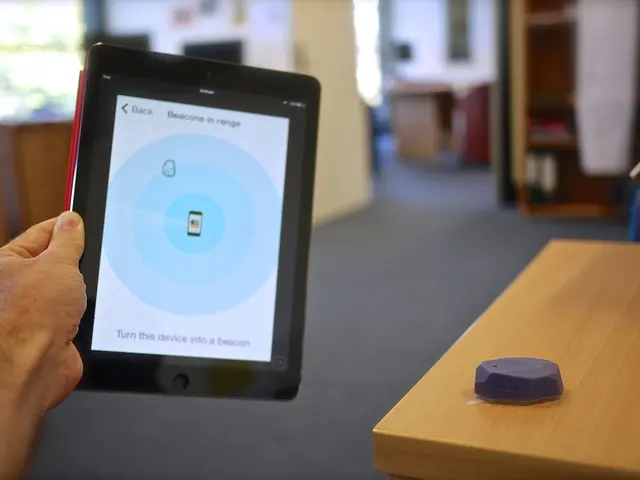 In this image, we can see a human hand is holding an iPad. On the right side, there is a wooden...