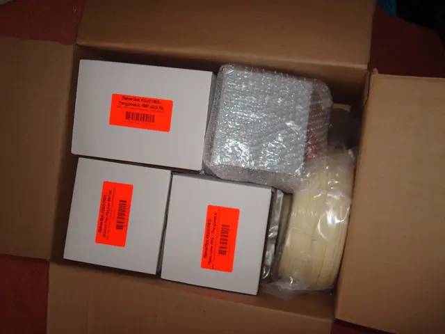 In this image I can see a cardboard box and in the box I can see few other boxes which are grey in...