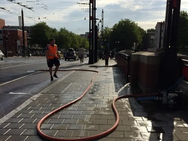 This image is clicked on the road. To the left there is a road. There are vehicles moving on the...