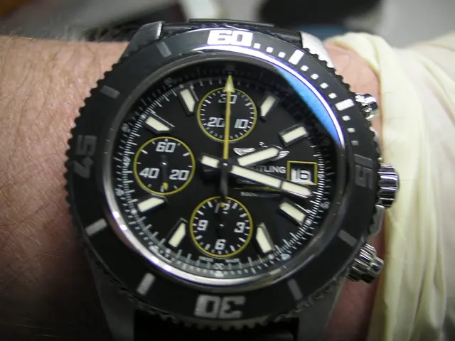 In this image I can see a watch on a person's hand. The watch is black in color.