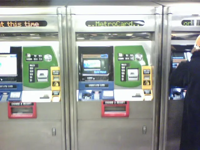 In this image we can see automatic ticket vending machines. On the right there is a person.