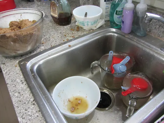 in this picture there are bowls, mugs and spoons in the kitchen sink. Beside to it there are...